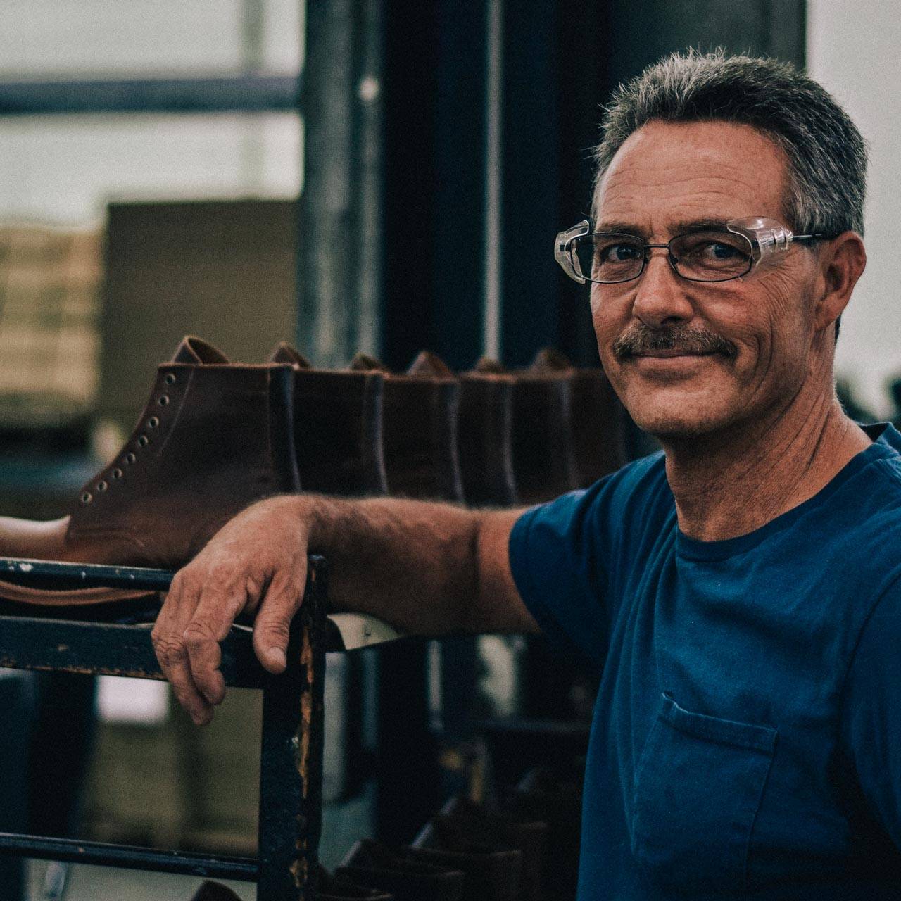 A proud bootmaker at an Oak Street Bootmakers Factory