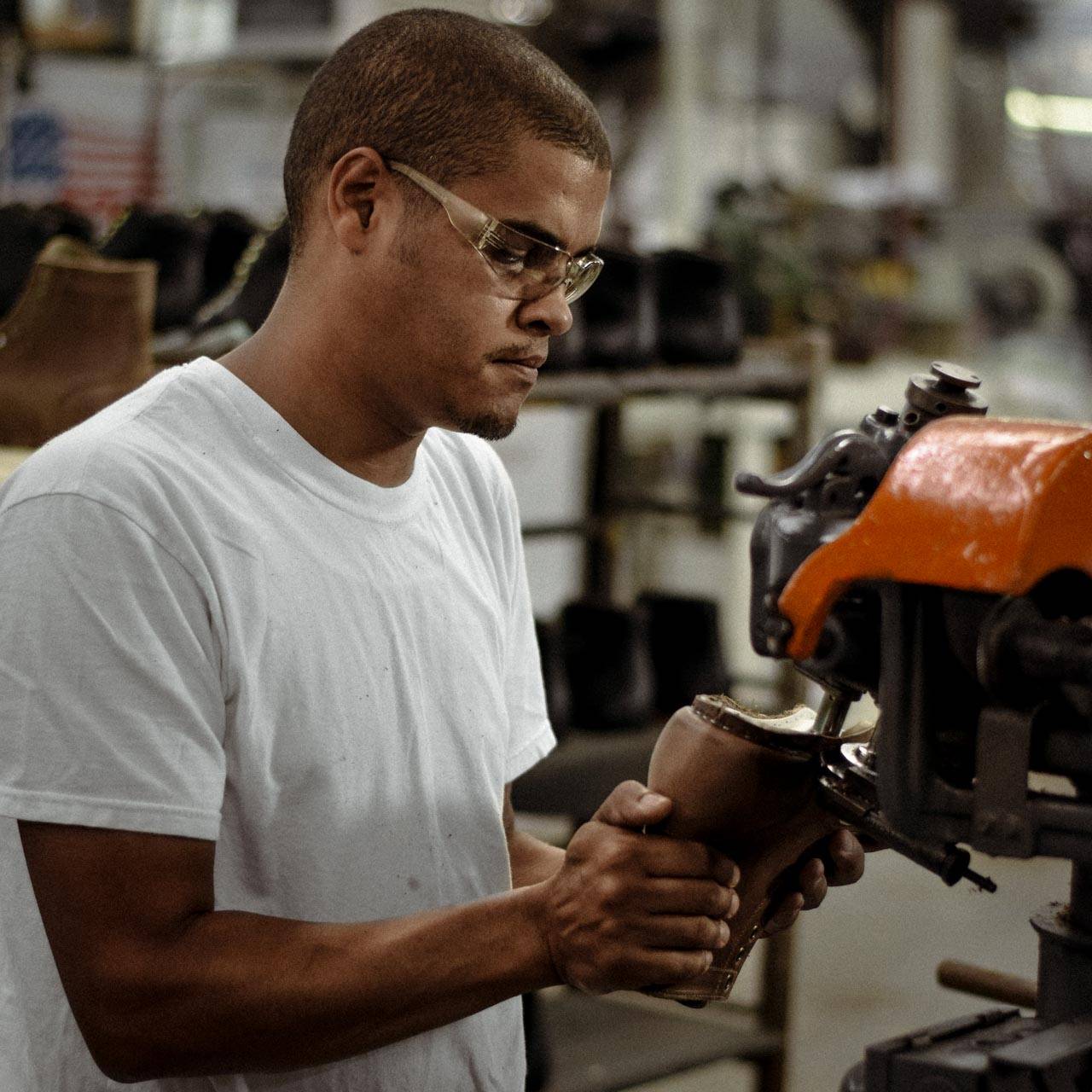 A skilled bootmaker operating a Goodyear Welt machine