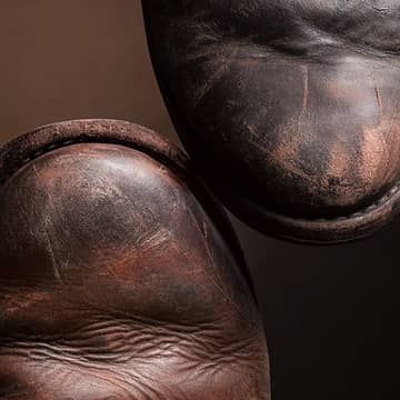 A close-up of well-worn Oak Street Bootmakers Trench Boots